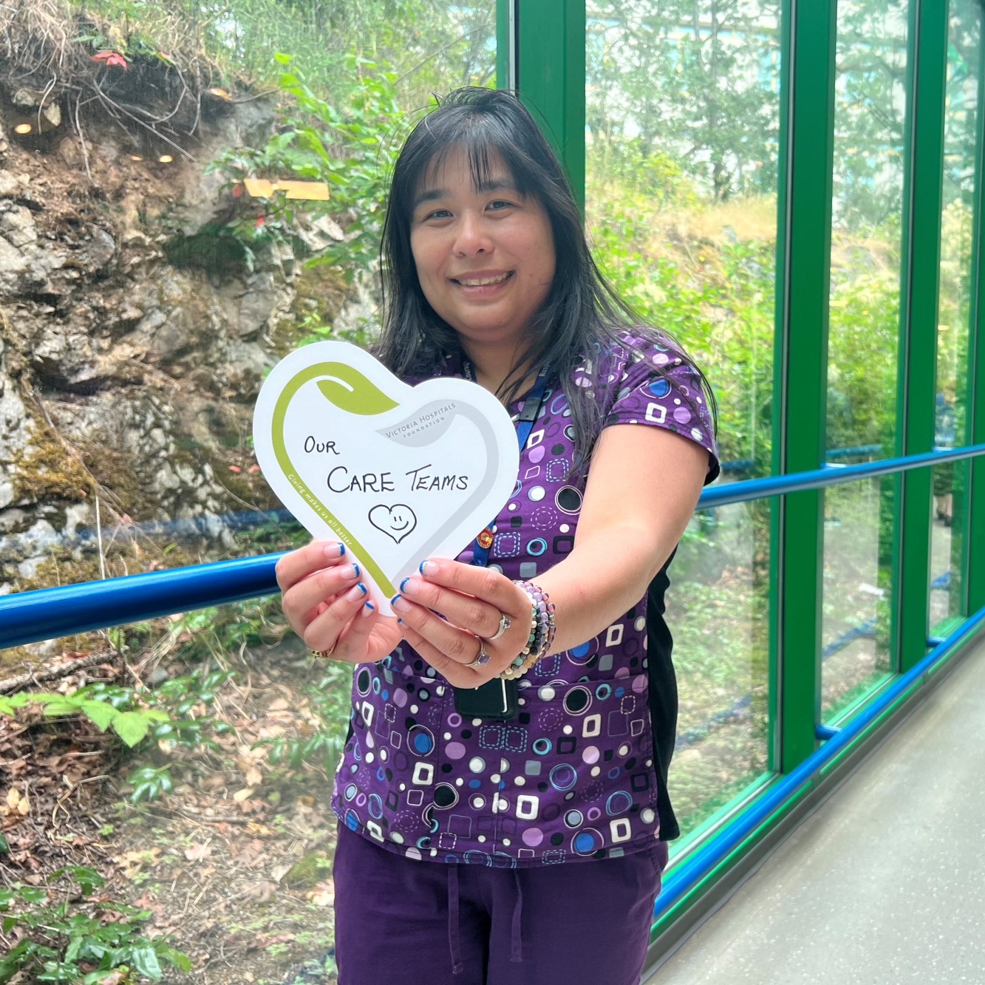 VHF Volunteer & Healthcare professional, Nancy Chiu, holding up a heart for our hospital's care teams at the Royal Jubilee Hospital.