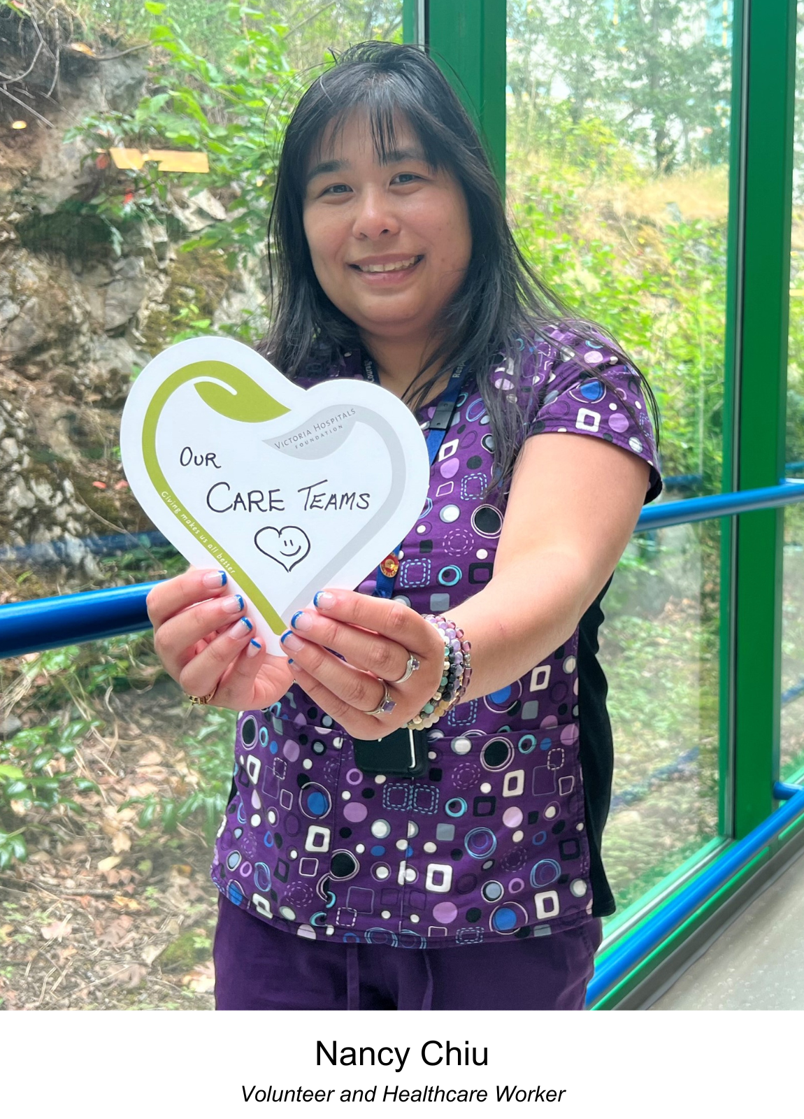 VHF Volunteer & Healthcare professional, Nancy Chiu, holding up a heart for our hospital's care teams at the Royal Jubilee Hospital.