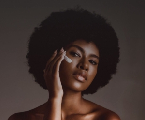 Philosophy MD presents: Philanthropy & Facials. Woman applying skin cream