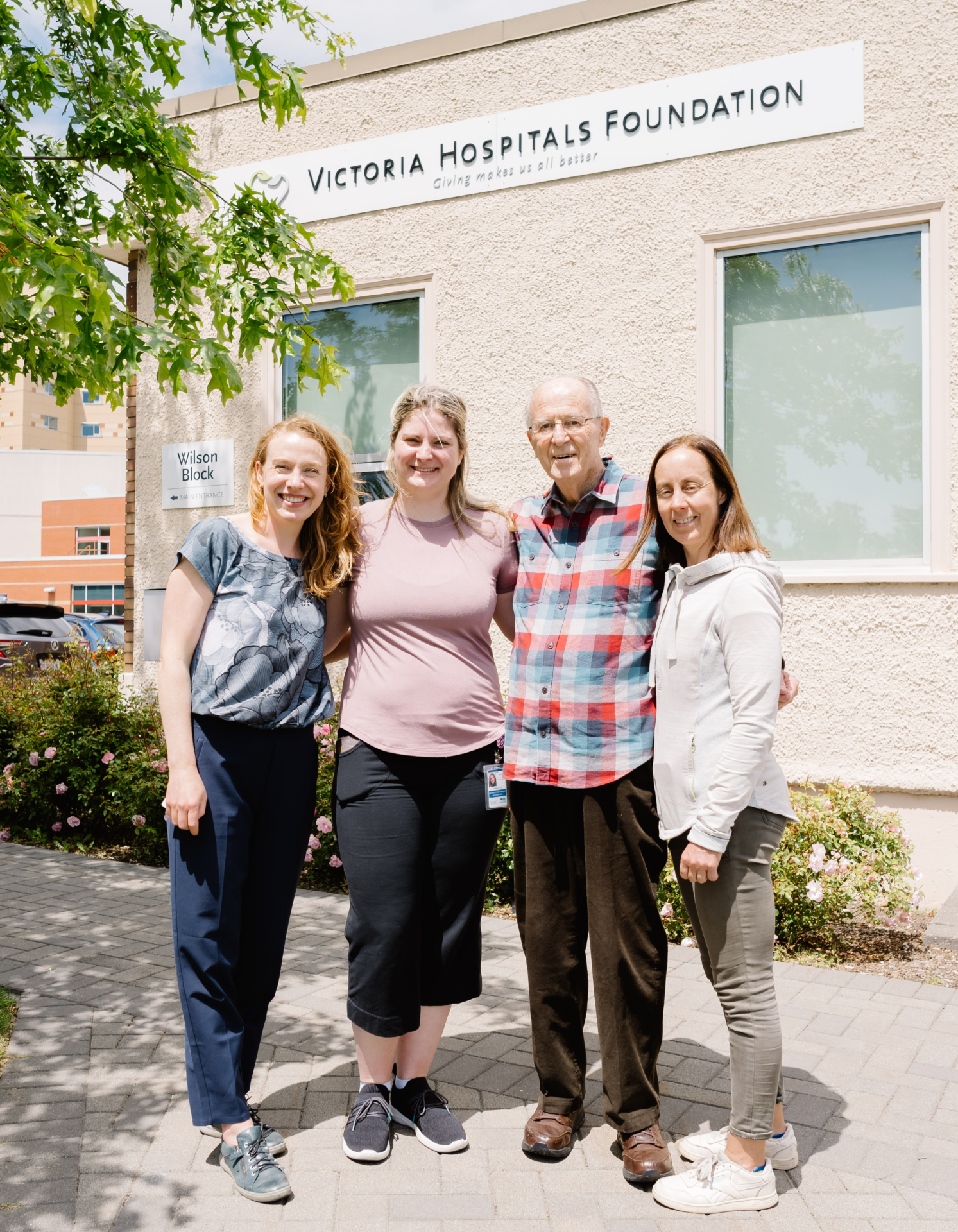 Richard & his caregivers stand together in front of VHF's office