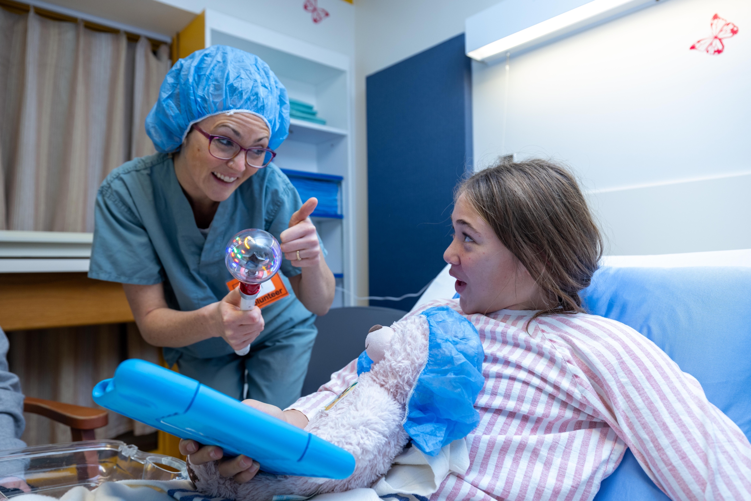 A Certified Child Life Specialist (CCLS) works with a young patient using donor-funded toys