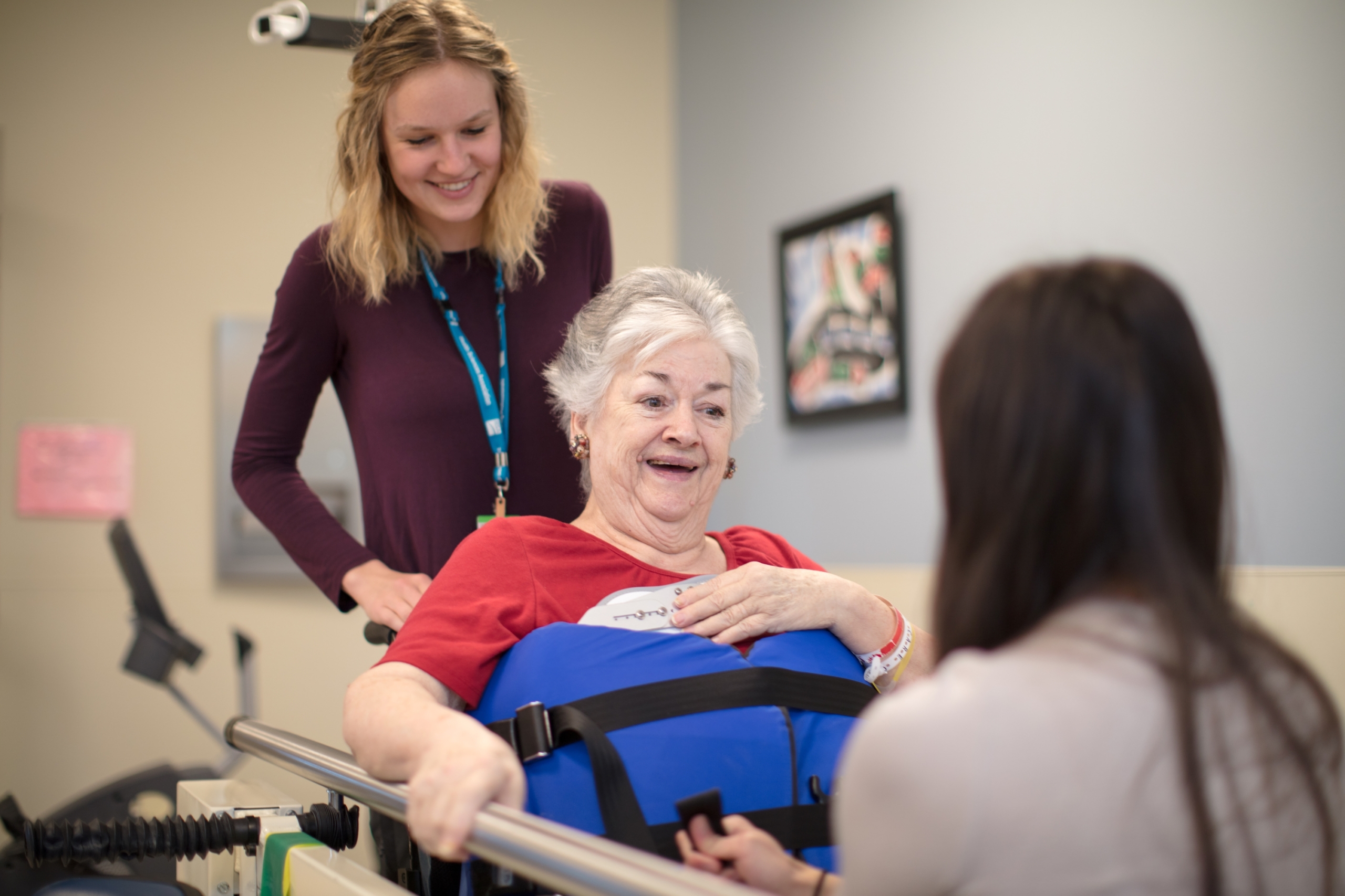 Patient in wheelchair with physiotherapists