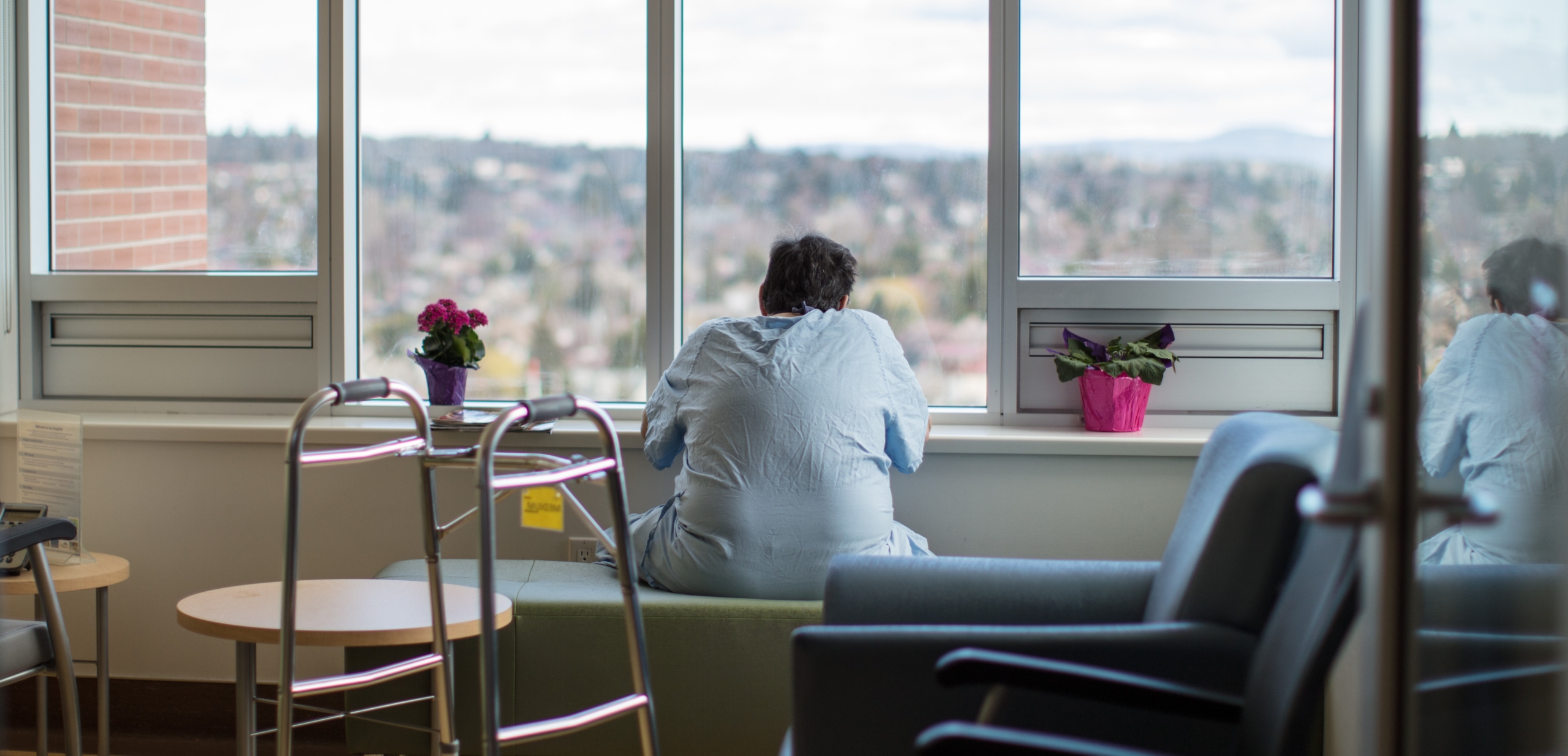 Patient staring out the window of his hospital room