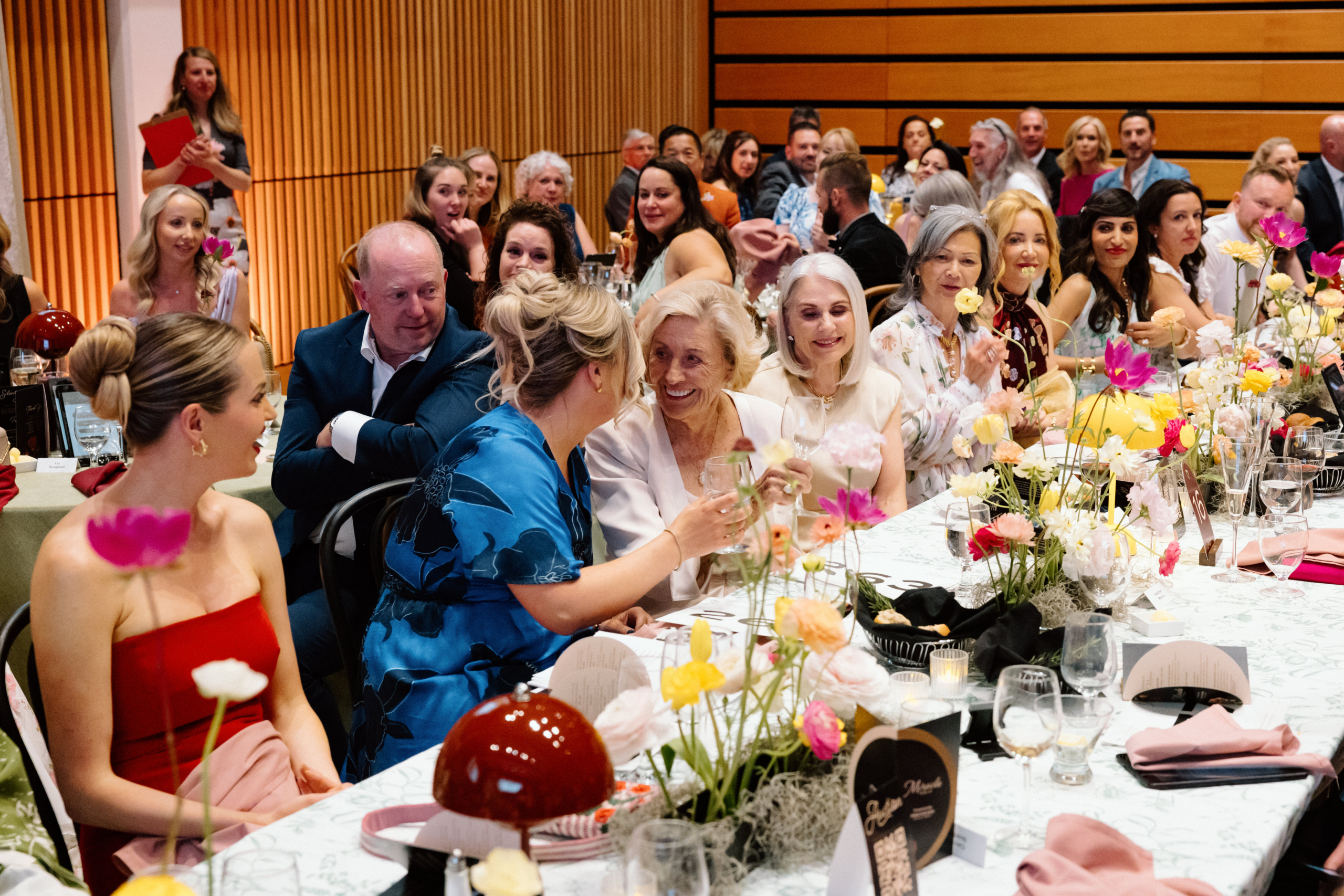 Guests of the Miracle Gala including Carol Forster and Avery Brohman celebrating together at a table