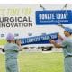 Drs. Mona Mazgani (Gynecologic Oncologist) and Sepehr Khorasani (Colorectal Surgeon) place the campaign completion decal on the Victoria Hospital Foundation's Campaign progress sign at Victoria General Hospital