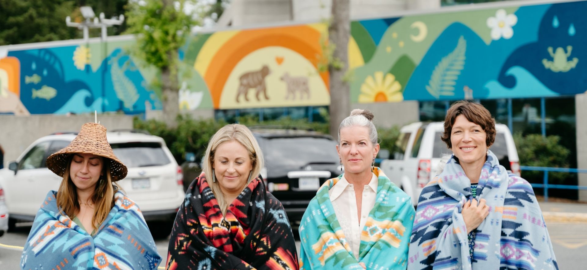 Artist Sarah Jim, Foundation CEO Avery Brohman, Donor & Accent Inns CEO Mandy Farmer, and Medical Director of VGH Dr. Chloe Lemire-Elmore being blanketed outside of Victoria General Hospital