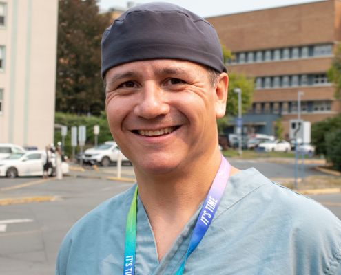 Dr. Cailan MacPherson, surgical oncologist, in front of Royal Jubilee Hospital