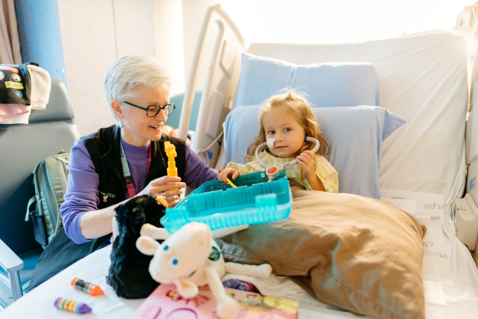 Childlife Specialist Diane Edwards playing with a pediatric patient at Victoria General Hospital (VGH)